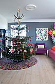 Christmas tree on round carpet in colorful living room