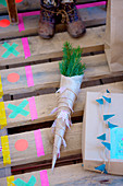 pine branches wrapped in paper with a pennant chain made of washi tape