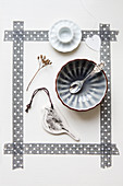 Bowl, bird pendant, and egg cup in a frame made of gray washi tape