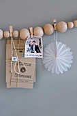 DIY garland of wooden beads and clothes pegs used as mood board