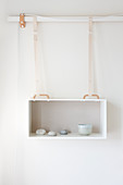 Hanging box as a wall shelf with a simple decoration