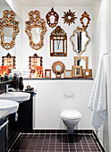 Collection of gold framed mirrors on the wall in the bathroom