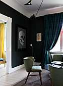 Retro armchair in living room with black wall and skull picture