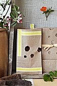 Homemade gift bags made of wrapping paper with cut out honeycomb shapes