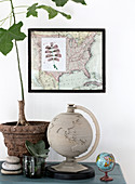 Still life globe, framed map, and fig trees