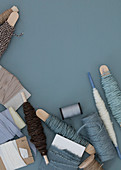Cord, sewing thread, and fabric ribbons in blue-gray and natural tones