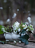 Snowdrops and ivy with ivy berries in a bowl