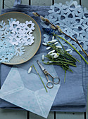 Grape hyacinth, pussy willow, and snowdrops on paper snowflakes