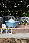 Bathtub next to the sink in a Mediterranean outdoor kitchen