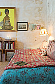 Day bed in the living room with worn walls and wooden boxes as a shelf