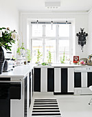 Kitchen with black and white striped fronts and runners with block stripes