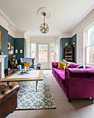 Pink sofa in classic living room with bay window in period building