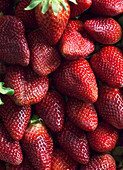 From above clean healthy ripe strawberries placed in pile