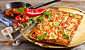 Pizza mit Paprika, Tomaten und Kräutern