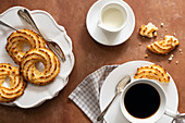 Cup of coffee served with coconut macaroons on a plate