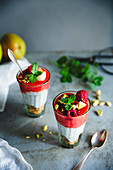 Chia pudding with raspberries and pistachio nuts in glasses
