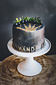 A mini blueberry cake with gold decorations