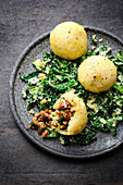 Stuffed potato dumplings with mushrooms on a bed of savoy cabbage