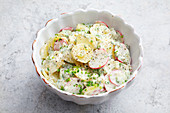 Creamy potato salad with radishes