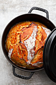 Potato bread with roasted onions in a cast-iron pot
