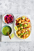 Deep fried cauliflower vegan tacos served with red cabbage salad and guacamole sauce