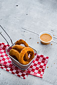 Fried ring onions with vegan chipotle sauce
