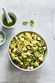 Pasta summer salad with vegan zucchini pesto, tofu, vegan parmigiano and roasted zucchini