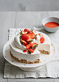 Ice cream cake with cereal base and strawberry sauce
