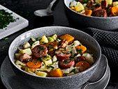 Cabbage stew with pumpkin and Mettenden (smoked pork sausage)