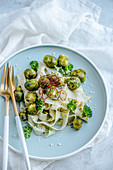 Pasta with Brussels sprouts, pesto, chili threads and Parmesan cheese