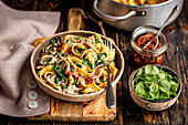 Tagliatelle with mushrooms, dried tomatoes, spinach and cheese