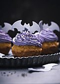 Vegan pumpkin cupcakes with elderberry cream frosting and rice paper decorations for Halloween
