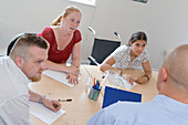 Office workers in a board room meeting