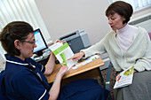 Patient looking at BMI chart with community nurse