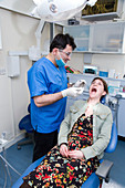 Dentist carrying out dental treatment on a patient