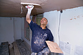 Man plastering the ceiling