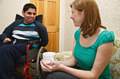 Social worker visiting disabled teenager at home