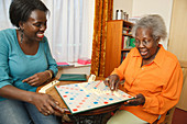 Daughter and mother playing scrabble