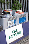 Old car batteries in bin at city tip