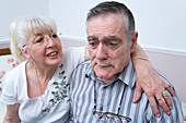 Woman with her arm around husband with Alzheimer's Disease