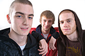 Studio portrait of three young men smiling