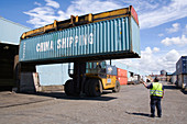 Shipping container being moved