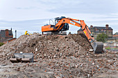 Heavy plant machinery on top of a pile of rubble