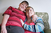 Young carer with his arm around his mum