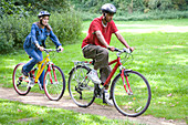 Woman and teenager out in the countryside cycling