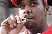 Young man taking a drag from a cigarette