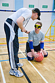 Coach talking to goalball player
