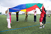 Group of children playing the parachute game