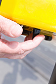 Vision impaired man feeling using a pelican crossing