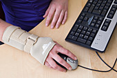 Office worker wearing an elasticated wrist support